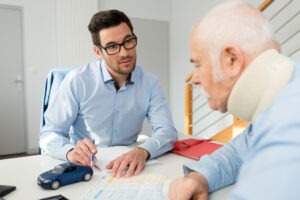 lawyer discussing liability with a client wearing a neck brace after suffering an injury in a pedestrian accident in Ohio.